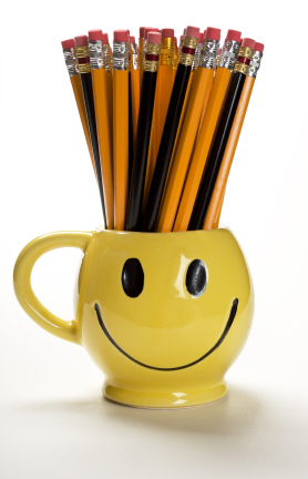 Smiling mug holding pencils