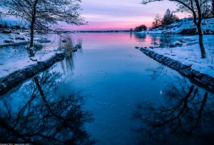 Sunset over a snowy lake.
